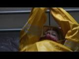 Pia tied and gagged in an yellow rainsuit on bed (Video)