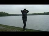 Enni wearing shiny nylon shorts and a rain jacket as well as a rain pants over the shorts (Video)