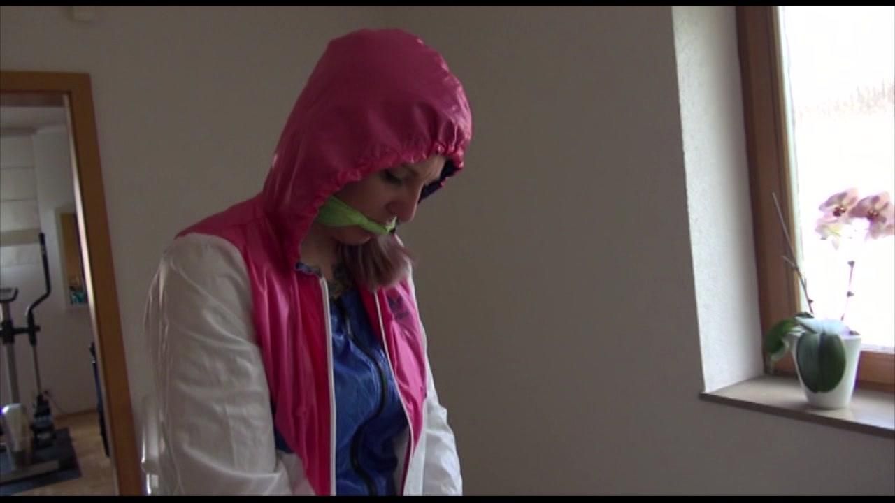 Mara Tied And Gagged With Cuffs On A Stairway Wearing Shiny Nylon Rainwear (Video)