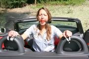 Stella tied and gagged in a grey shiny nylon catsuit in a car