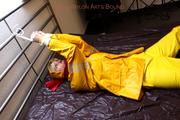 Pia tied and gagged in a shiny nylon rainsuit 