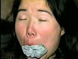 25 YEAR OLD ASIAN MAI-LING IS MOUTH STUFFED, CLEAVE GAGGED, HANDGAGGED, OTM GAGGED, TAPE GAGGED & TIGHTLY TIED TO A CHAIR  (D47-15)