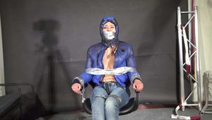 Alice bound and gagged in a shiny nylon Downjacket