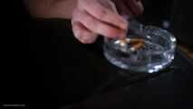 Police woman is smoking 3 strong reds in the studio