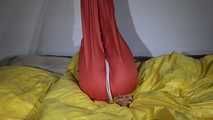 Watching Sandra  wearing an orange shiny nylon rain pants and a yellow shiny nylon rain jacket being tied and gagged on a bed with ropes and a clothgag (Video)