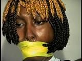 21 Yr OLD BLACK COLLEGE STUDENT GETS MOUTH STUFFED, WRAP TAPE GAGGED WHILE TIED TO A CHAIR  WEARING BLACK LINGERIE, GARTER BELT & HIGH HEELS (D65-4)