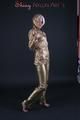 Blonde archive girl posing in a studio wearing a sexy golden rainwear combination (Pics)