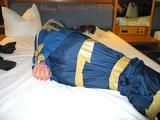 One of our archive girls bound and gagged in a blue shiny rainsuit 