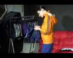 Lucy wearing a sexy blue shiny nylon pants and an orange rain jacket while folding clothes (Video)