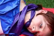 Nicole in an blue sauna suit tied and gagged in the garden (Pics)
