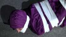 Sexy Sandra wearing a supersexy purple shiny nylon rainsuit bein tied and gagged and hooded on the floor with tape (Video)