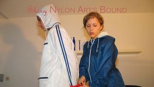 Leonie ties, gagges and hoodes Stella both wearing sexy shiny rainwear (Pics)