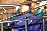 Mara tied and gagged on a princess bed in an old cellar wearing an supersexy shiny green down jacket and a rain pants (Pics)