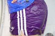 Sonja taking a shower wearing a very hot purple shiny nylon shorts and a blue rain jacket (Pics)