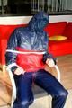 Katharina tied and gagged in a shiny nylon rainsuit
