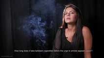 Asya is giving an interview while smoking two cigarettes