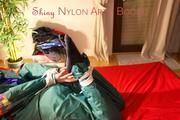 Lucy tied and gagged on bed wearing a sexy green rainwear combination (Pics)