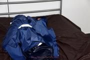 Simone tied and gagged in a shiny nylon rainsuit and a shiny nylon cape