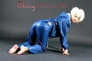 Blonde angel posing in a studio wearing sexy Blue AGU shiny nylon rainwear (Pics)