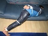 Katharina tied, gagged and hooded (breath control) on a sofa wearing sexy blue shiny nylon rainwear (Pics)