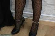 Leather lady cuffed to the heater