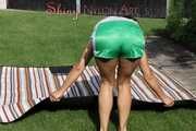 Sexy Sandra lying in the sun and feeling good wearing a green shiny nylon shorts and a white tshirt (Pics)