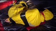 Sonja tied, gagged and hooded on bed with tape wearing a supersexy yellow rainwear combination (Video)