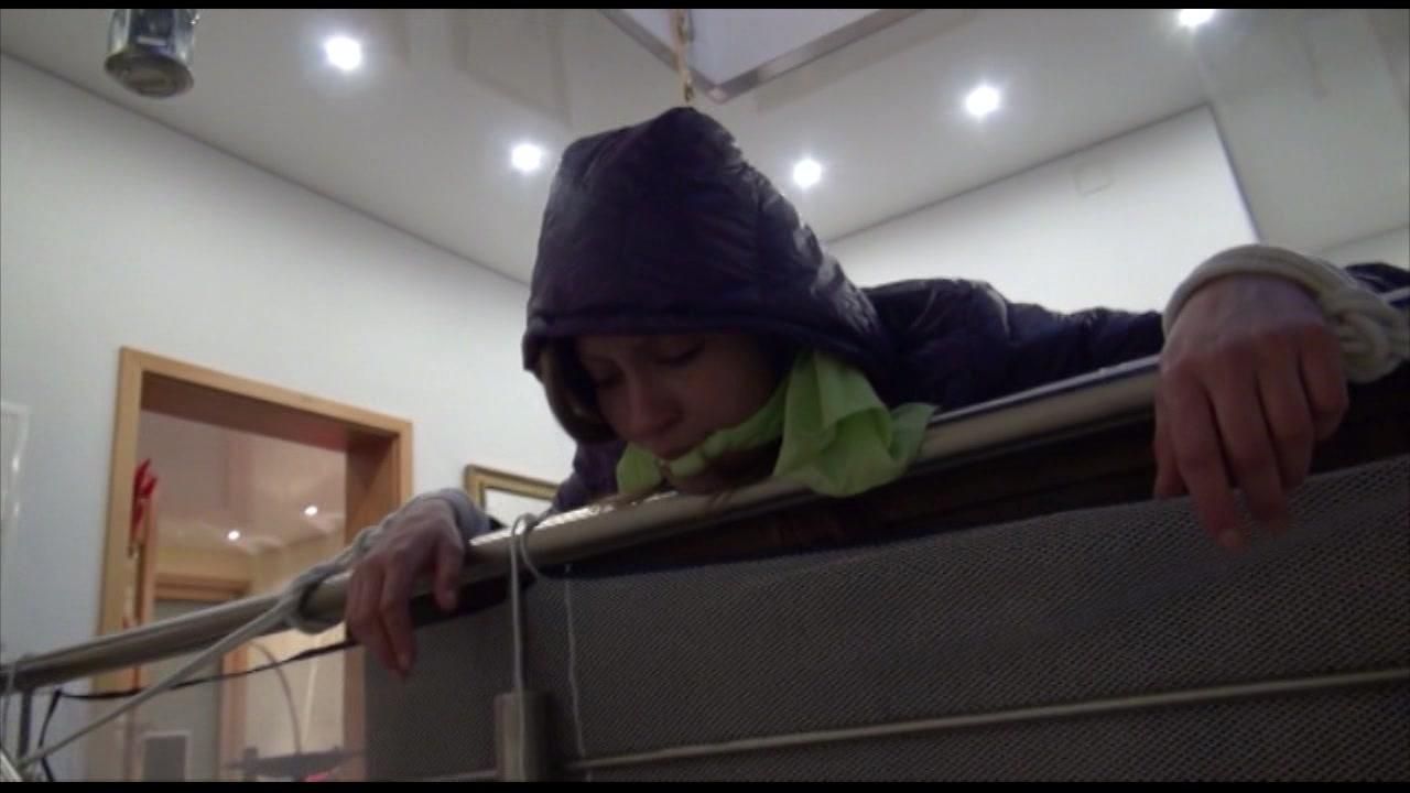 Alina Tied And Gagged On A Commode Wearing A Shiny Red/Purple Downwear Combination (Video)