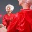 Blonde archive girl posing infront of a mirror wearing sexy red shiny nylon shorts and a red rain jacket (Pics)