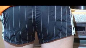 Sonja cleaning up the kitchen wearing a sexy black shiny nylon shorts and an orange rain jacket (Video)