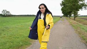 Miss Amira on the road in a Frisian mink, yellow rain dungarees and rubber boots