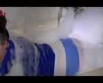 Jill posing and playing with water and foam in the bath tub wearing a sexy lightblue shiny nylon shorts and an oldschool blue rain jacket (Video)