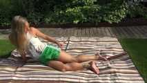 Watching sexy Sandra wearing a sexy green shiny nylon shorts and a white top taking a sun bath (Video9