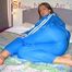 Katharina lolling on the bed wearing lightblue sexy shiny nylon rainwear (Pics)