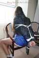 Stella being tied and gagged with ropes and a clothgag on a chair wearing a sexy shiny nylon short and a rain jacket (Pics)