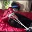 Lucy tied and gagged on bed wearing a sexy black shiny nylon pants and a red down jacket (Video)