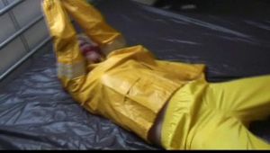 Pia tied and gagged in an yellow rainsuit on bed (Video)