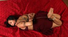 Ballgagged barefoot Lois, hogtied with hemp rope, is tickled and spanked by the man