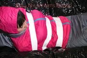 Mara tied, gagged and hooded with tape on a sexy black covered sofa wearing a supersexy grey rain pants and a pink rain jacket (Pics)