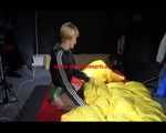 Sexy Sonja wearing a green shiny nylon shorts and a black rain jacket lolling in shiny nylon linen (Video)