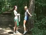 An archive girl tied and gagged on a tree by Jill both wearing shiny nylon shorts (Video)