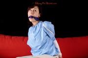 Julia tied and gagged in a shiny PVC suit