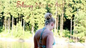 Jenny sunbathing on a lake and go swimming wearing sexy shiny nylon shorts and a bikini-top (Pics)