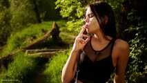 18 years old Tanya is smoking 120mm cork cigarette outdoors