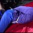 Sonja tied and gagged with ropes and a ballgag on a bed covered with a red shiny nylon cloth wearing a blue shiny nylon rain pants and a purple rain jacket (Video)