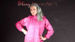 Mara wearing a sexy pink rainsuit posing infront of the camera in a studio (Pics)