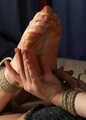 Barefoot Doris in bra and shorts, hogtied with hemp rope, rolls and wiggles on the bed