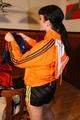 Jill wearing a sexy black nylon shorts and a orange rain jacket while dressing her up (Pics)