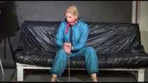 Pia ties and gagges herself with cuffs wearing a sexy green shiny nylon down suit (Video)