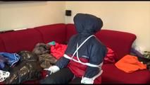 Jill tied, gagged and double hooded on a chair wearing shiny nylon shorts and two shiny nylon rain jackets (Video)